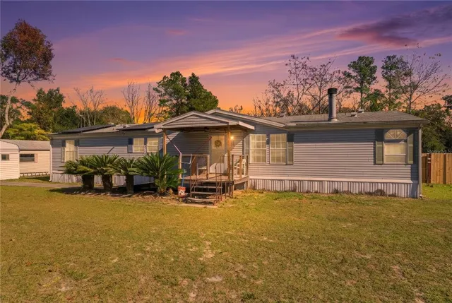 a view of a house with patio and a garden