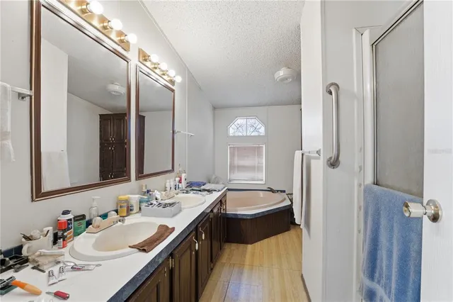 a en suite bathroom with a double vanity sink a mirror and a shower