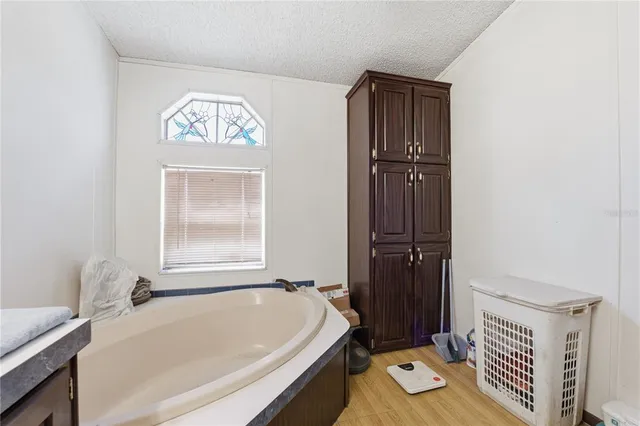a bathroom with a tub and a window