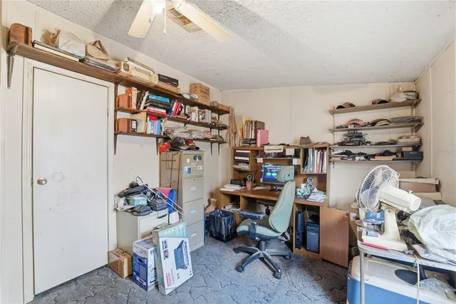a view of a room with workspace and a window