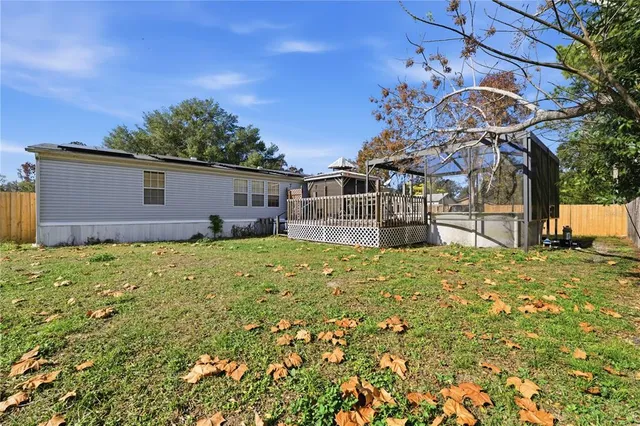 a view of a backyard with a tree