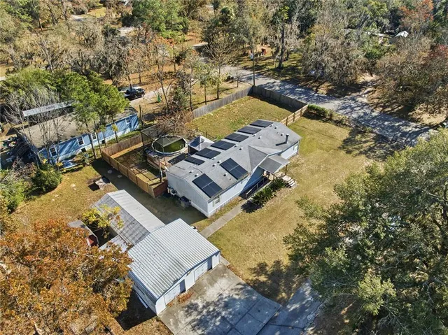 an aerial view of residential houses with outdoor space and swimming pool