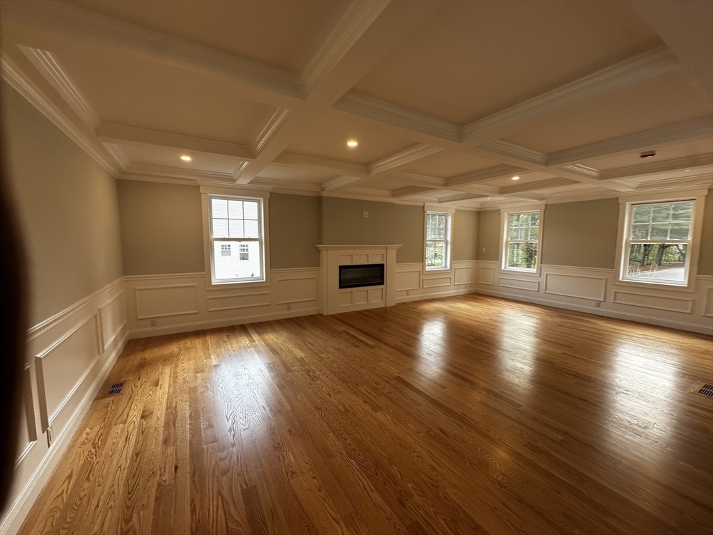 56 Dudley Road Billerica, MA 01821 - Photo 6 of 29 an empty room with wooden floor and windows