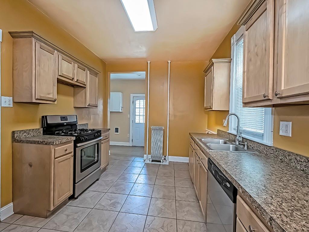 449 Library Avenue Carnegie, PA 15106 - Photo 11 of 22 a kitchen with stainless steel appliances granite countertop a sink stove and refrigerator