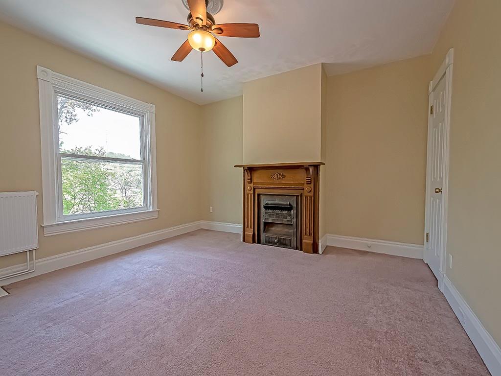 449 Library Avenue Carnegie, PA 15106 - Photo 12 of 22 an empty room with windows and fireplace