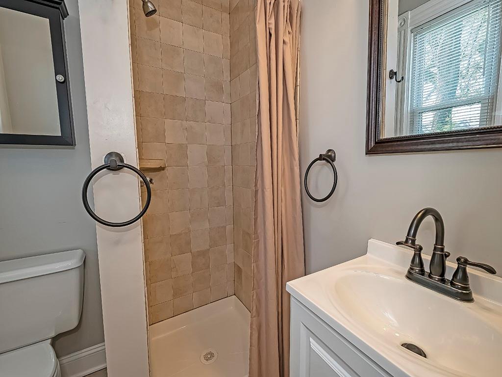 449 Library Avenue Carnegie, PA 15106 - Photo 19 of 22 a bathroom with a granite countertop sink toilet and a mirror