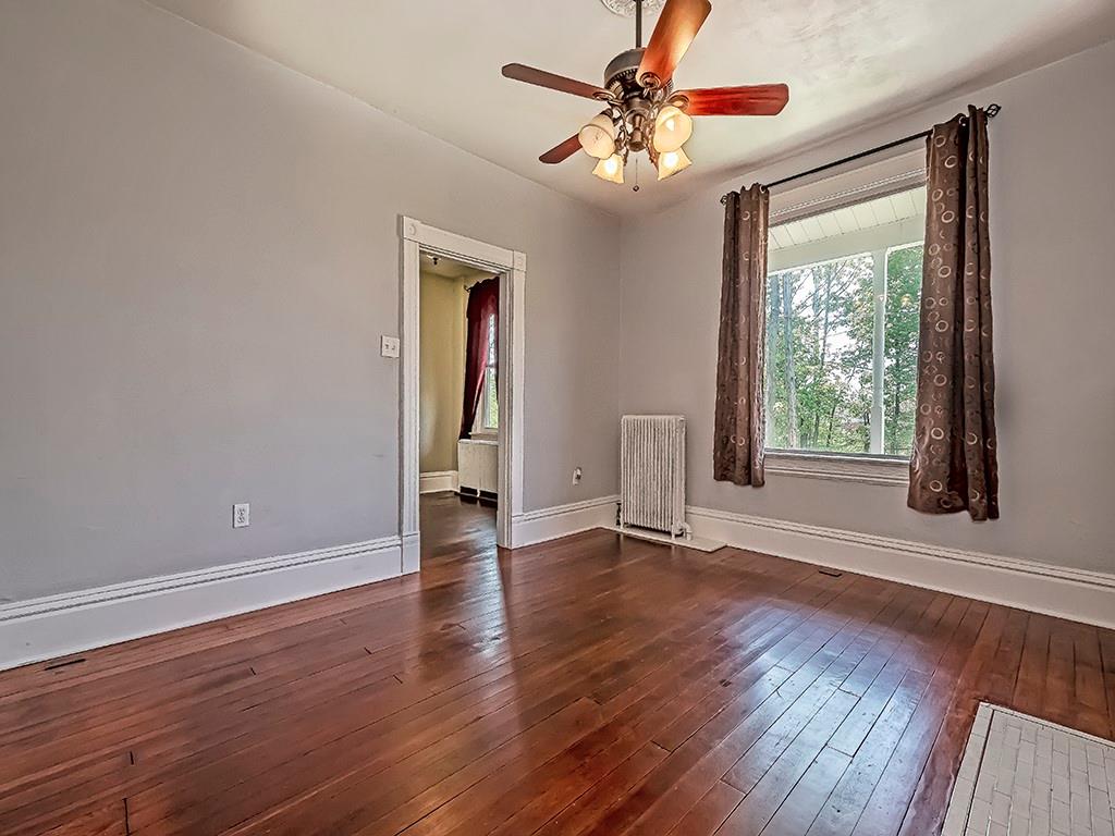 449 Library Avenue Carnegie, PA 15106 - Photo 6 of 22 a view of an empty room with wooden floor and a window