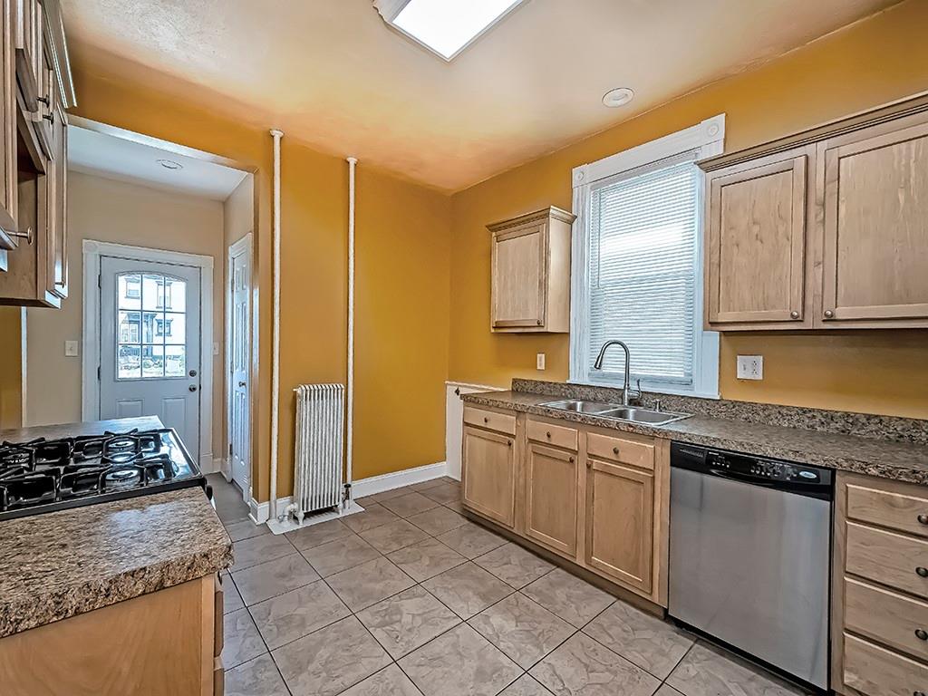 449 Library Avenue Carnegie, PA 15106 - Photo 9 of 22 a kitchen with stainless steel appliances granite countertop a sink stove and cabinets