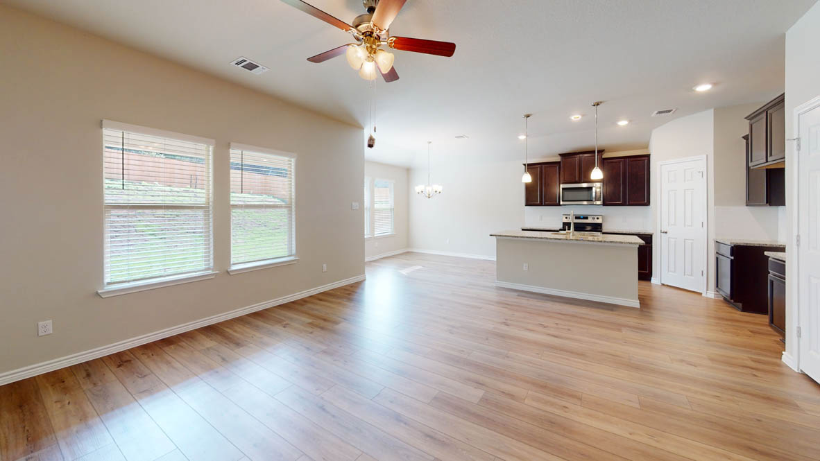 429 Creekfall Road Burnet, TX 78611 - Photo 9 of 28 An open-concept living space with lustrous hardwood-style flooring and abundant natural light.