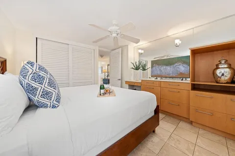 a spacious bedroom with a bed and a table