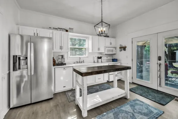 a kitchen with kitchen island stainless steel appliances a sink stove and refrigerator
