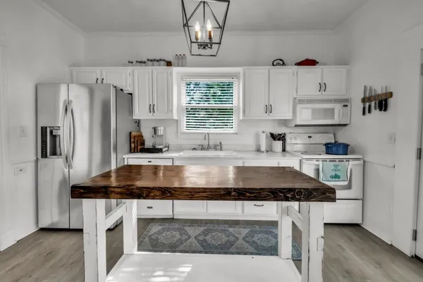 a kitchen with granite countertop a sink stainless steel appliances and cabinets