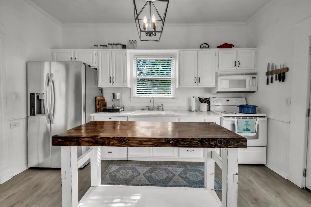 911 Highway 85 Connector Brooks, GA 30205 - Photo 13 of 45 a kitchen with kitchen island stainless steel appliances a sink stove and refrigerator