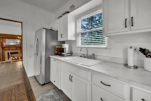 a kitchen with stainless steel appliances granite countertop a sink stove and cabinets