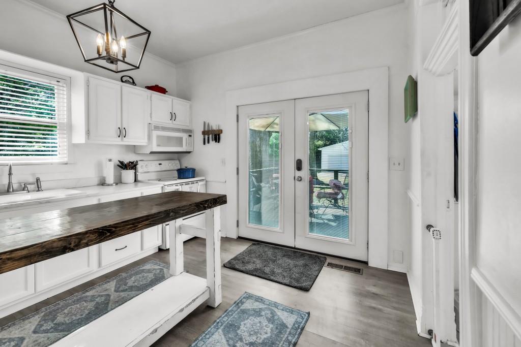 911 Highway 85 Connector Brooks, GA 30205 - Photo 16 of 45 a kitchen with granite countertop stainless steel appliances a sink stove and cabinets