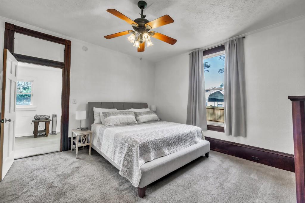 911 Highway 85 Connector Brooks, GA 30205 - Photo 22 of 45 a bedroom with a bed and a chandelier