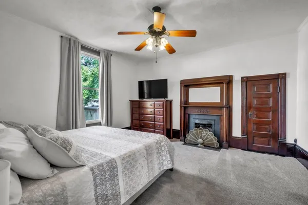 a bedroom with a bed and a fireplace