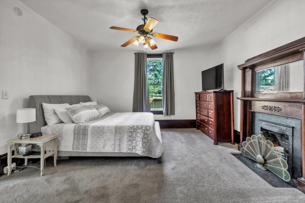 911 Highway 85 Connector Brooks, GA 30205 - Photo 24 of 45 a bedroom with a bed and a fireplace