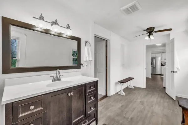 a bathroom with a sink vanity and a mirror