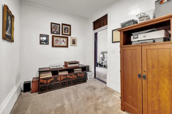 a view of a hallway with workspace and a living room