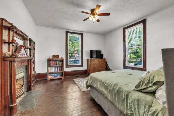 a bedroom with a bed lamps and window