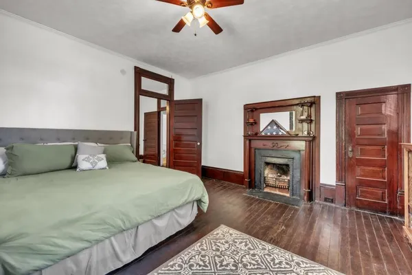a bedroom with a bed and a fireplace