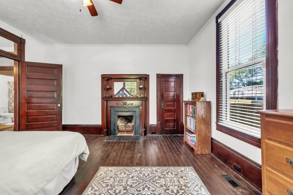 911 Highway 85 Connector Brooks, GA 30205 - Photo 33 of 45 a bedroom with a bed and a fireplace