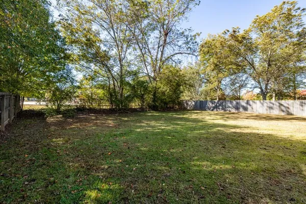 a view of yard with swimming pool and trees
