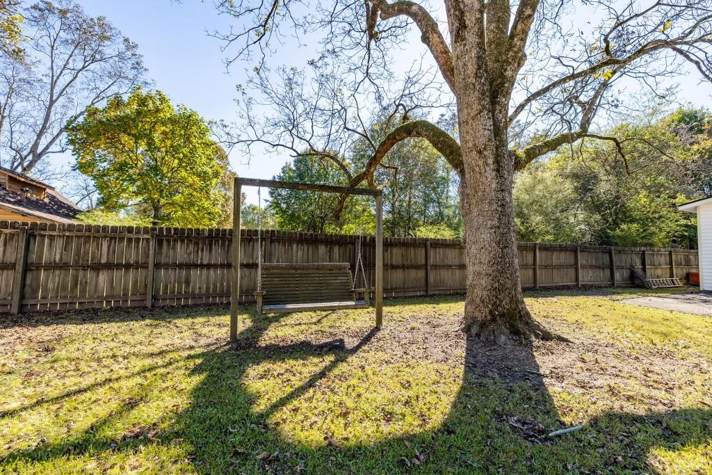 911 Highway 85 Connector Brooks, GA 30205 - Photo 43 of 45 a view of a backyard with wooden fence and a large tree