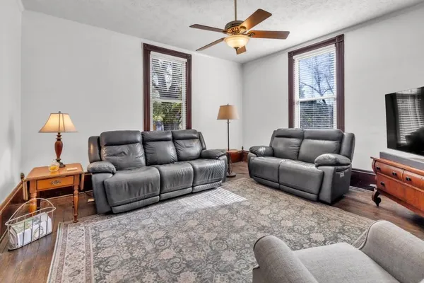 a living room with furniture a flat screen tv and a fireplace
