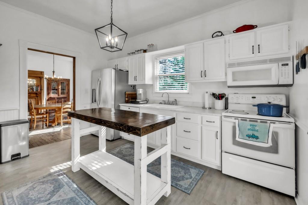 911 Highway 85 Connector Brooks, GA 30205 - Photo 10 of 45 a kitchen with granite countertop a sink and white cabinets