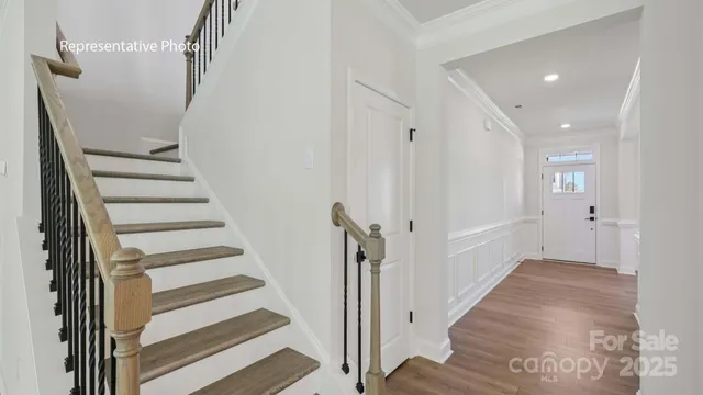 a view of a hallway with wooden floor and entryway