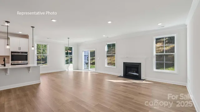 an empty room with windows and a fireplace