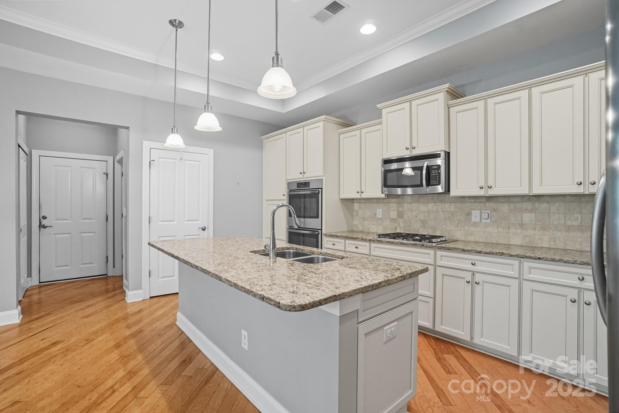 2232 Coltsview Lane Matthews, NC 28105 - Photo 14 of 42 a kitchen with kitchen island granite countertop a sink cabinets and stainless steel appliances