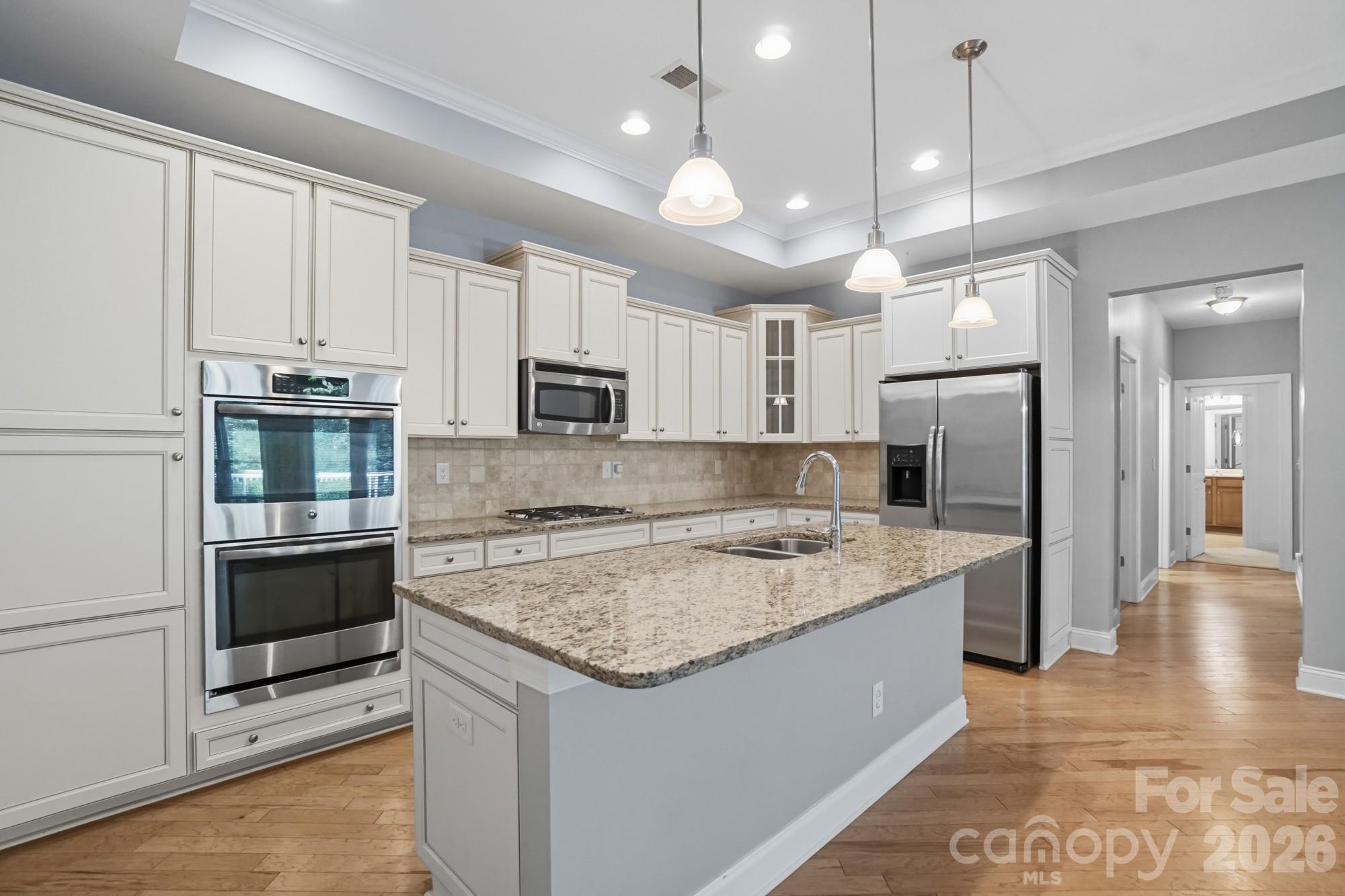 2232 Coltsview Lane Matthews, NC 28105 - Photo 15 of 47 a kitchen with a center island a counter space stainless steel appliances and cabinets