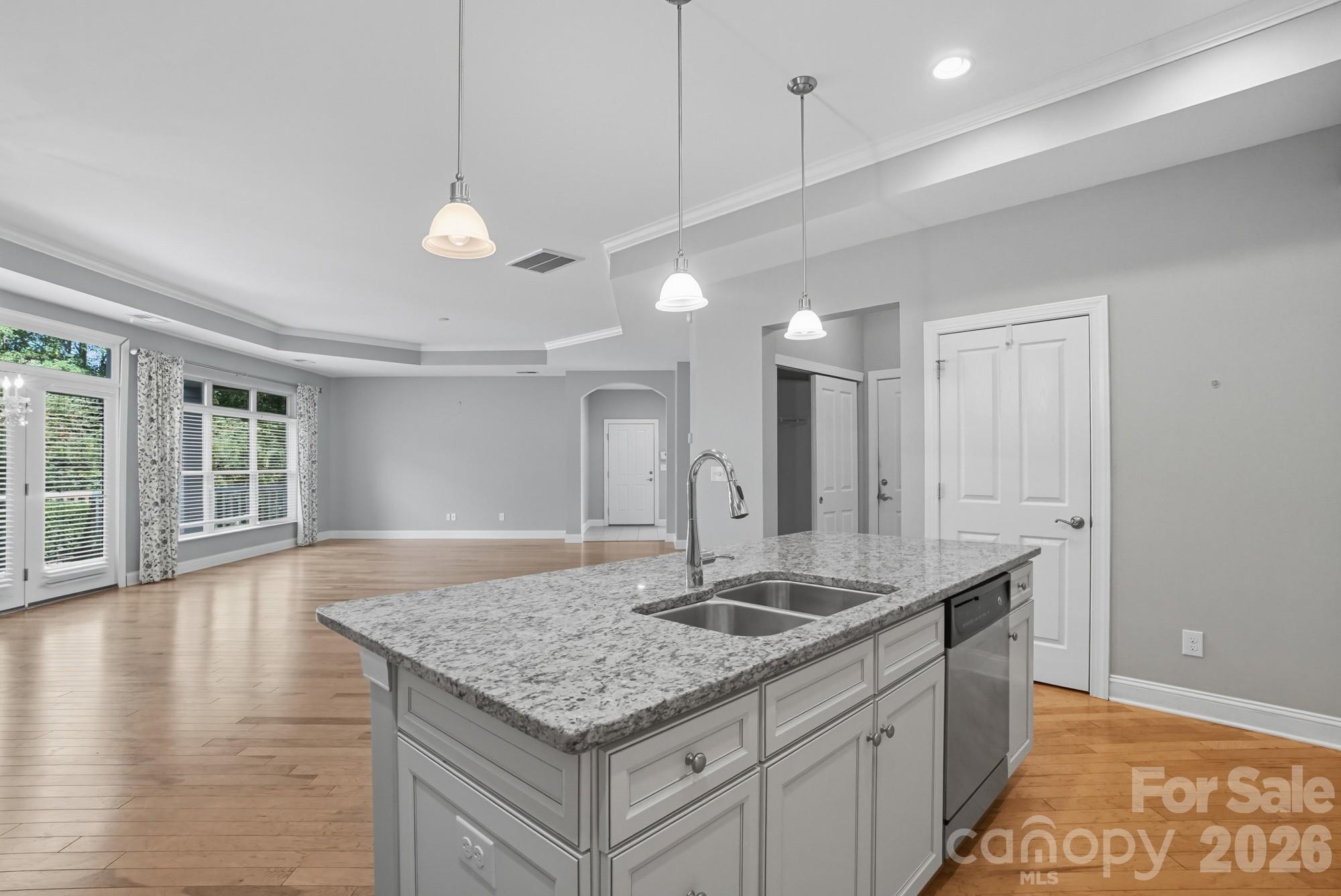 2232 Coltsview Lane Matthews, NC 28105 - Photo 18 of 47 a kitchen with granite countertop a sink cabinets and wooden floor
