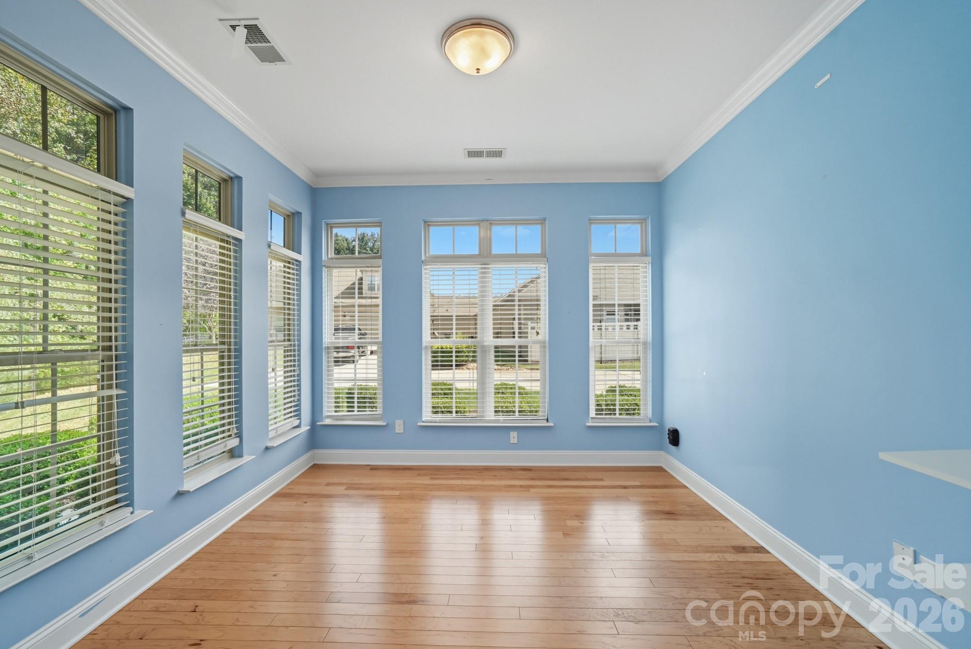 2232 Coltsview Lane Matthews, NC 28105 - Photo 19 of 47 a view of an empty room with a window and wooden floor