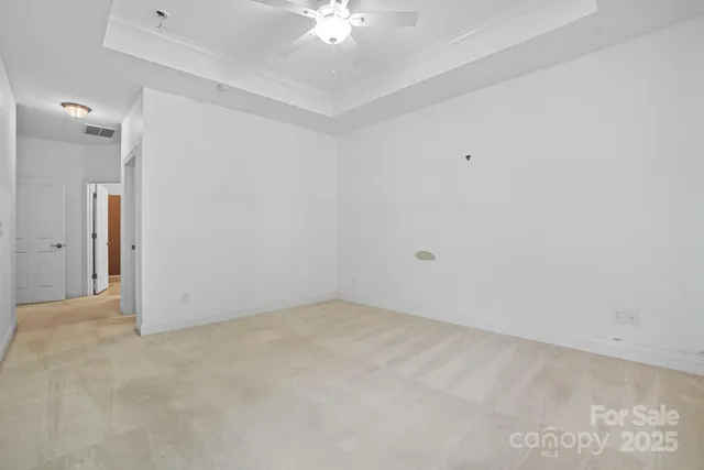 a view of walk in closet with empty racks