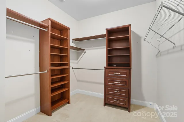 a spacious bathroom with a double vanity sink a large mirror and shower