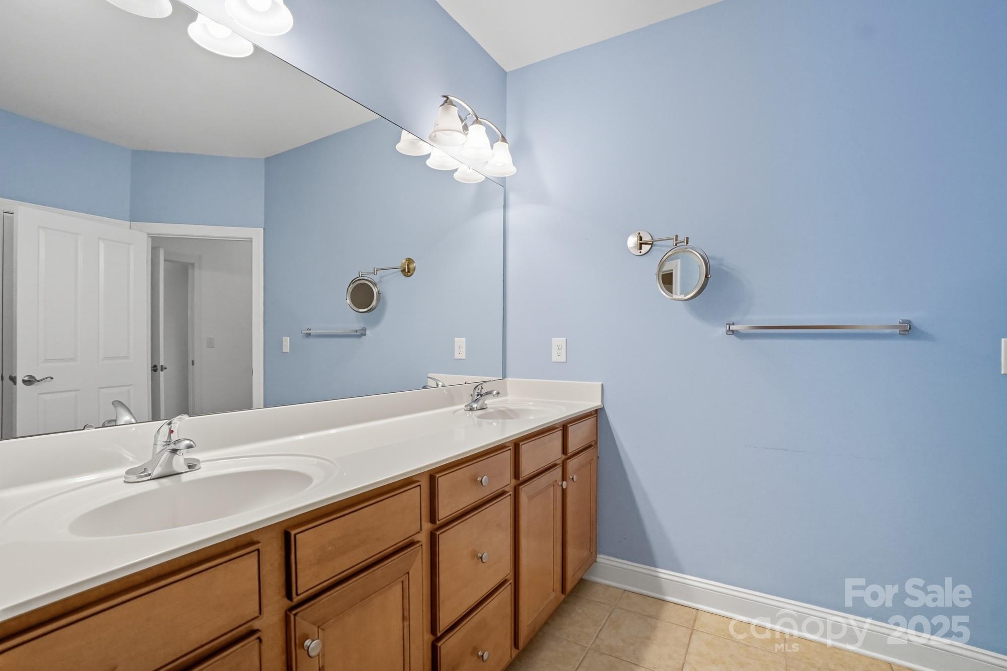 2232 Coltsview Lane Matthews, NC 28105 - Photo 26 of 42 a bathroom with a double vanity sink and a mirror