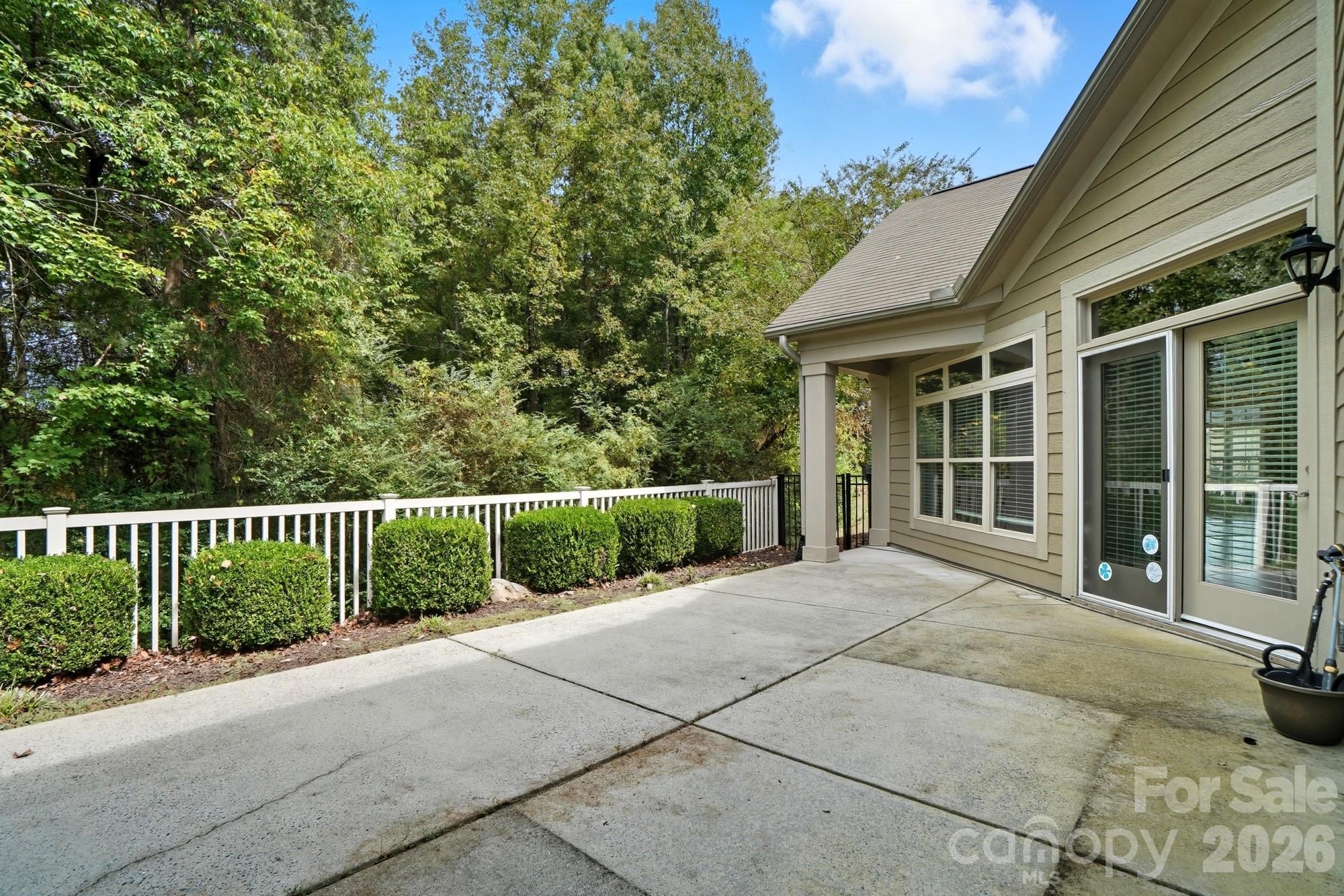 2232 Coltsview Lane Matthews, NC 28105 - Photo 37 of 47 a view of a house with a floor to ceiling window and wooden fence