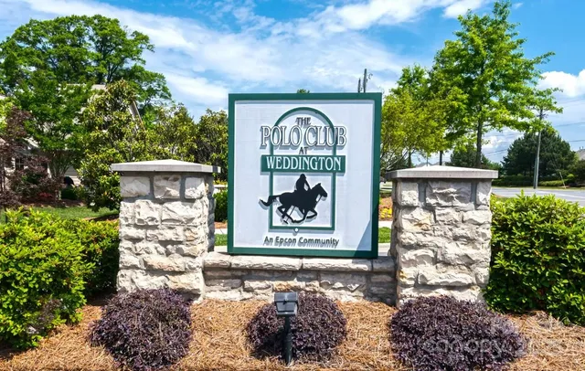a living room with fireplace furniture and a large window