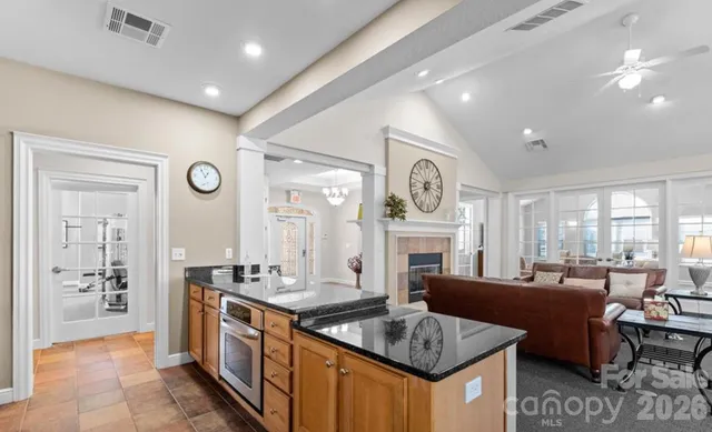 a living room with fireplace furniture and a large window