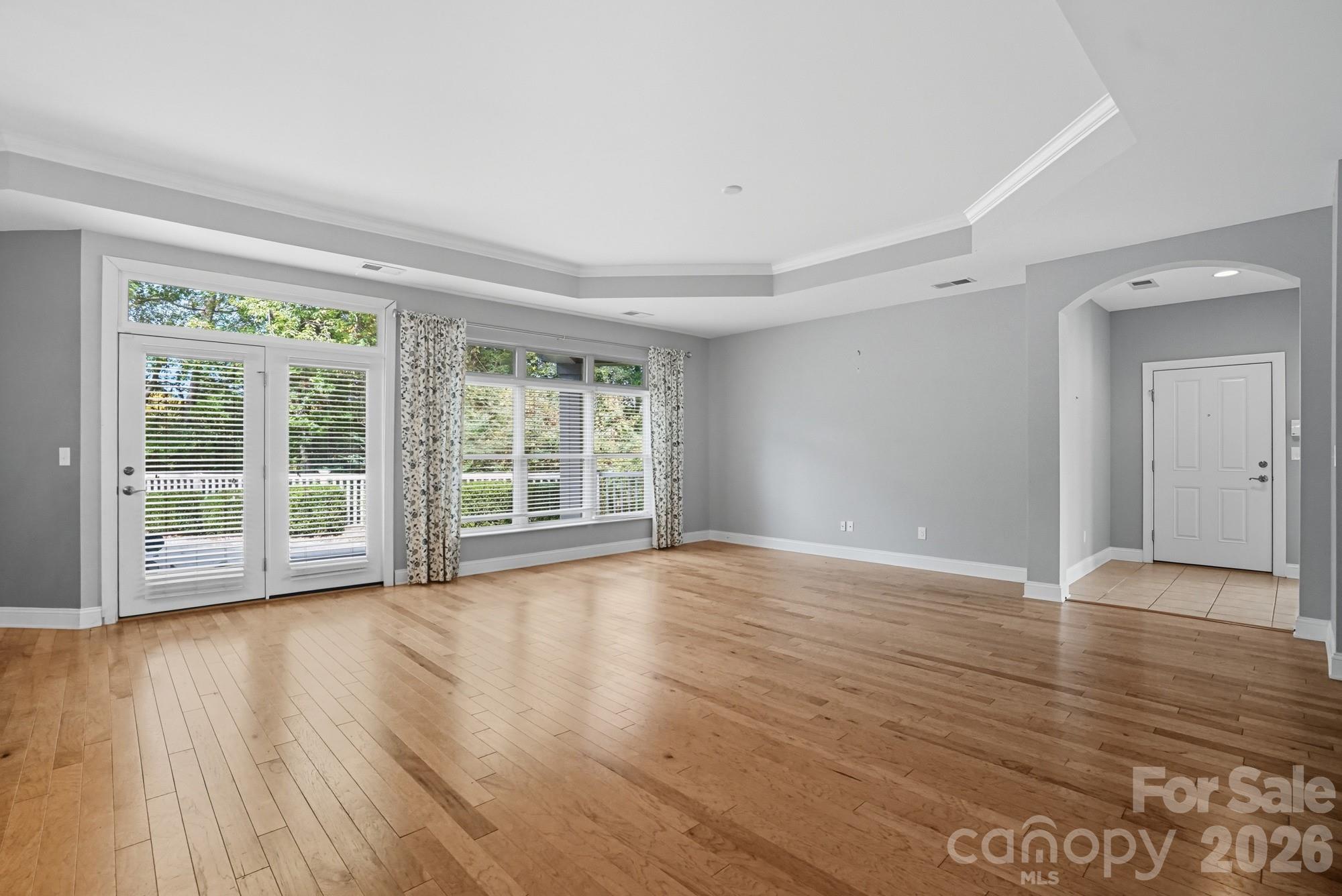 2232 Coltsview Lane Matthews, NC 28105 - Photo 9 of 47 a view of an empty room with wooden floor and a window