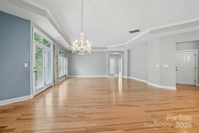 a view of a kitchen with wooden floor and a kitchen