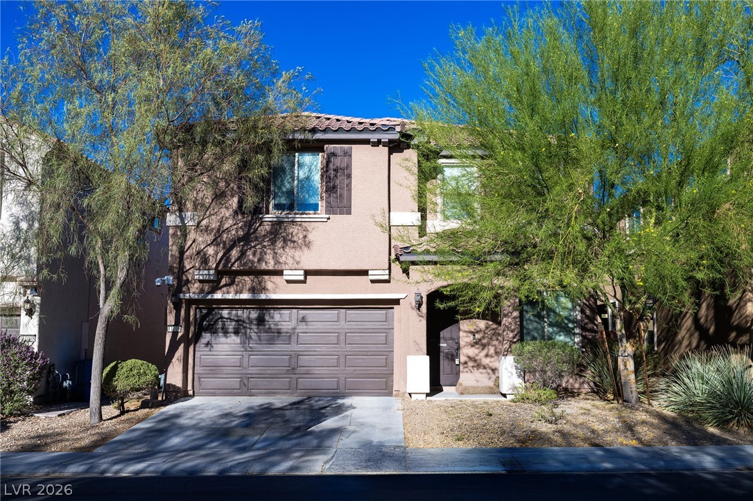 11016 Prairie Grove Road Las Vegas, NV 89179 - Photo 3 of 37 A classic facade with shuttered windows, inviting entry, and an attached garage.