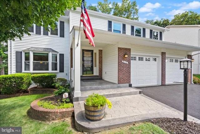a front view of a house with a garden and a fire pit