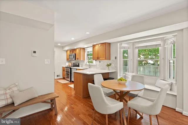 a living room with furniture a rug and a chandelier