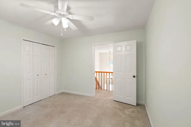 a bathroom with a toilet a sink a vanity and a window