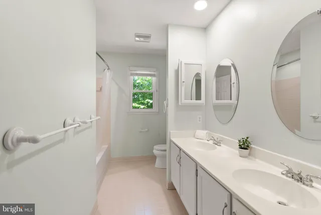 a bathroom with a sink shower and a mirror